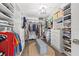 Expansive walk-in closet with custom shelving, drawers, and ample storage for clothes, shoes, and accessories at 13102 Foxtail Fern Dr, Riverview, FL 33579