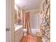Bathroom featuring a shower/tub combo with modern wood-look flooring at 13210 Arbor Isle Dr # 207, Temple Terrace, FL 33637