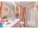 Bright bathroom features a shower/tub combo, vanity with sink, and neutral decor at 13210 Arbor Isle Dr # 207, Temple Terrace, FL 33637