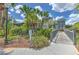 Clubhouse featuring tropical landscaping, a bridge, and ample parking at 13210 Arbor Isle Dr # 207, Temple Terrace, FL 33637