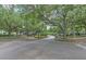 Street view showcasing mature trees and well-maintained landscaping in community at 13210 Arbor Isle Dr # 207, Temple Terrace, FL 33637