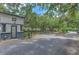 Community entrance with trees, gate house, and tree-lined streets at 13210 Arbor Isle Dr # 207, Temple Terrace, FL 33637