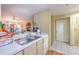 A kitchen with modern countertops, leading to the cozy living room and offering a functional layout at 13210 Arbor Isle Dr # 207, Temple Terrace, FL 33637