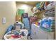 The laundry room contains laundry supplies, cleaning appliances, and a washer/dryer unit at 13210 Arbor Isle Dr # 207, Temple Terrace, FL 33637