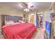 Large main bedroom featuring ceiling fan, and doorways to bathroom and walk-in closet at 13210 Arbor Isle Dr # 207, Temple Terrace, FL 33637