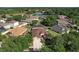 Aerial view of a home with a screened lanai, surrounded by lush greenery, and other homes in a friendly neighborhood at 1408 Brilliant Cut Way, Valrico, FL 33594