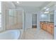 Bathroom featuring soaking tub, walk-in shower, and dual sinks at 1408 Brilliant Cut Way, Valrico, FL 33594