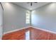 Clean and well-lit bedroom with hardwood floors, ceiling fan, and neutral color scheme at 1408 Brilliant Cut Way, Valrico, FL 33594