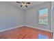 Simple bedroom features hardwood floors and a ceiling fan at 1408 Brilliant Cut Way, Valrico, FL 33594
