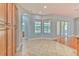 Cozy breakfast nook with large windows, tile floor, and archway into hall at 1408 Brilliant Cut Way, Valrico, FL 33594