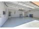 Spacious three car garage with epoxy flooring, high ceilings, and ample storage space at 1408 Brilliant Cut Way, Valrico, FL 33594