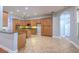 Well-equipped kitchen with ample wood cabinets, an island, and tiled floors at 1408 Brilliant Cut Way, Valrico, FL 33594