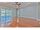 Bright, open living room featuring hardwood floors, recessed lighting, and a sliding door leading to a patio at 1408 Brilliant Cut Way, Valrico, FL 33594