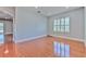 Light filled room featuring hardwood flooring, recessed lights, and large shuttered window at 1408 Brilliant Cut Way, Valrico, FL 33594