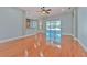 Open floor plan featuring hardwood floors with a view of an outdoor pool through sliding glass doors at 1408 Brilliant Cut Way, Valrico, FL 33594