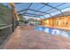 Inviting screened-in pool with brick pavers and lights creating a relaxing backyard retreat at 1408 Brilliant Cut Way, Valrico, FL 33594
