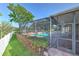 Inviting screened-in pool area with lush landscaping, brick pavers, and ample room for relaxation at 1408 Brilliant Cut Way, Valrico, FL 33594
