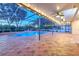 Inviting screened-in pool area with brick pavers, lights, and ceiling fans for outdoor relaxation and entertainment at 1408 Brilliant Cut Way, Valrico, FL 33594