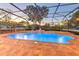 Inviting screened-in pool with brick pavers, fountain and lights creating a relaxing backyard retreat at 1408 Brilliant Cut Way, Valrico, FL 33594