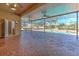Covered lanai with brick pavers overlooks a stunning screened-in pool and spa area with lush landscaping at 1408 Brilliant Cut Way, Valrico, FL 33594