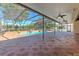 Expansive screened pool patio featuring brick pavers, ceiling fans, and a tranquil pool with water feature at 1408 Brilliant Cut Way, Valrico, FL 33594