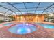 Inviting screened-in pool with brick pavers, fountain and lights creating a relaxing backyard retreat at 1408 Brilliant Cut Way, Valrico, FL 33594