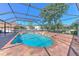 Inviting pool features a screened enclosure, brick-paved patio, and a relaxing spa for outdoor enjoyment at 1408 Brilliant Cut Way, Valrico, FL 33594