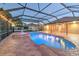 Inviting screened-in pool with brick pavers, fountain and lights creating a relaxing backyard retreat at 1408 Brilliant Cut Way, Valrico, FL 33594