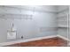 Spacious walk-in closet with white shelving and wood-style floors for ample storage and organization at 1408 Brilliant Cut Way, Valrico, FL 33594