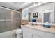 Well-maintained bathroom features a shower, a toilet, and a vanity with ample counter space at 1657 Glengarry Dr, Palm Harbor, FL 34684