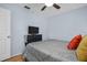 Simple bedroom features a television, hardwood floors, and access to the hallway at 1657 Glengarry Dr, Palm Harbor, FL 34684