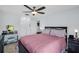 Cozy bedroom features a ceiling fan, neutral walls, and a vanity with lighted mirror at 1657 Glengarry Dr, Palm Harbor, FL 34684