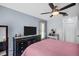 Bedroom features a ceiling fan, closet, and adjacent vanity area at 1657 Glengarry Dr, Palm Harbor, FL 34684