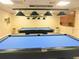 Community billiard room featuring two pool tables with lighting fixtures at 1657 Glengarry Dr, Palm Harbor, FL 34684