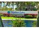 Well maintained community entrance featuring mature palms and attractive water feature at 1657 Glengarry Dr, Palm Harbor, FL 34684