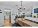 Open-concept dining area with chandelier lighting, connecting to the living room and kitchen, great for gatherings at 1657 Glengarry Dr, Palm Harbor, FL 34684