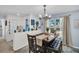 Inviting dining area featuring a modern chandelier, comfortable seating, and nautical-themed decor at 1657 Glengarry Dr, Palm Harbor, FL 34684