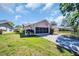 Charming home exterior with a well-manicured lawn and inviting curb appeal at 1657 Glengarry Dr, Palm Harbor, FL 34684
