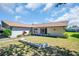 Well-maintained single-story home with mature landscaping and a welcoming front entrance at 1657 Glengarry Dr, Palm Harbor, FL 34684
