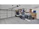 Spacious garage providing ample storage and parking space, golf cart and fans at 1657 Glengarry Dr, Palm Harbor, FL 34684