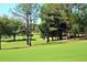 Rolling golf course with lush green grass and mature trees, offering a peaceful and scenic view at 1657 Glengarry Dr, Palm Harbor, FL 34684