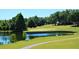 A stunning view of the golf course from a nearby lake and winding path at 1657 Glengarry Dr, Palm Harbor, FL 34684