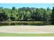 Picturesque golf course view with a serene pond, and lush greenery, offering a tranquil setting at 1657 Glengarry Dr, Palm Harbor, FL 34684