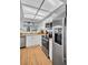 Well-lit kitchen with stainless steel appliances, white cabinetry, and light wood countertops at 1657 Glengarry Dr, Palm Harbor, FL 34684