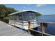 Pontoon boat parked on the lake dock, ready for a pleasant ride at 1657 Glengarry Dr, Palm Harbor, FL 34684