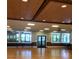 Spacious recreation room features a wall of windows, ceiling fans, and a gleaming hardwood floor at 1657 Glengarry Dr, Palm Harbor, FL 34684