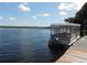 Breathtaking waterfront view showcasing a boat tied to the dock with clear blue skies at 1657 Glengarry Dr, Palm Harbor, FL 34684