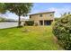 Expansive backyard with fire pit and covered patio area at 18243 Cypress Bay Pkwy, Land O Lakes, FL 34638