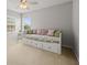 Bright bedroom with a daybed, soft carpet, and two windows for natural light at 18243 Cypress Bay Pkwy, Land O Lakes, FL 34638