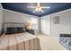 Cozy bedroom with gray walls, blue ceiling, and comfortable furnishings at 18243 Cypress Bay Pkwy, Land O Lakes, FL 34638